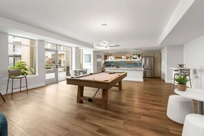 A modern living space with a pool table, a dining area, and a kitchen. - Landing | Amazing 2BD, Gym, Courtyard (Concord)