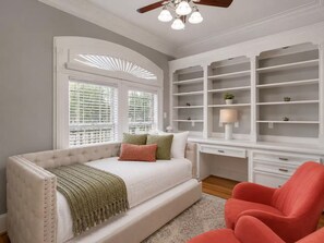 A bedroom with a bed, a desk, and built-in shelving. - Spacious Houston Retreat Sleeps 26 (Houston)