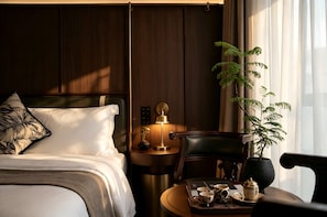 A hotel room with a bed, bedside table, lamp, chair, and a tray with teaware. - Relanding Hotel Zhuhai Gongbei Port (zhuhai)