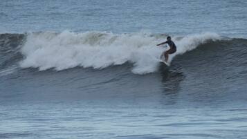 A person surfing on a wave in the ocean.