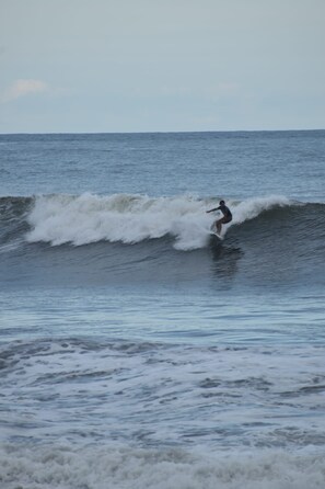 A person surfing on a wave in the ocean. - Vrbo Property (Mizata)