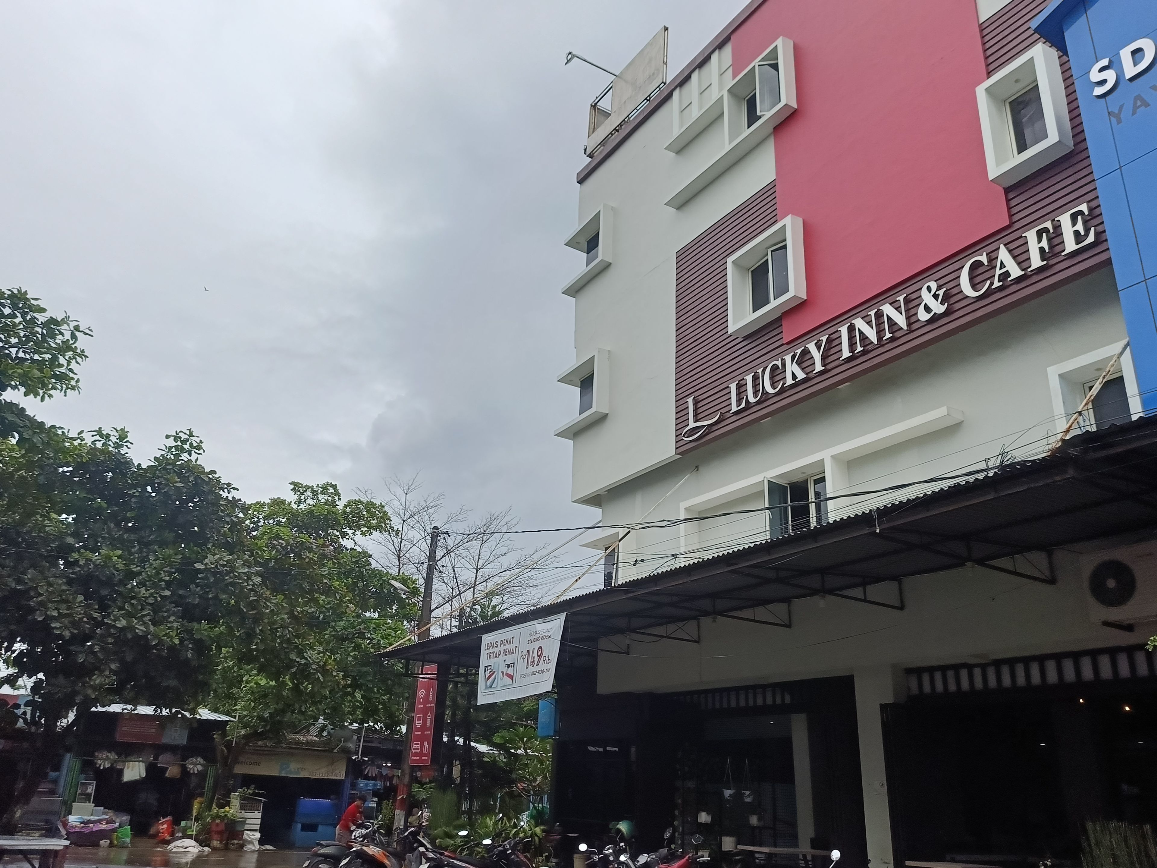 A multi-story building with a sign for 'Lucky Inn & Cafe' on the facade.