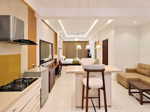 A modern hotel room with a kitchenette, a dining area, a sofa, and a bar area. - Apna Colombo (Colombo)