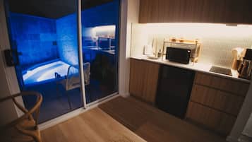 A modern kitchen with a microwave, sink, and wooden cabinets.