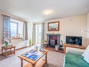 A cozy living room with a fireplace, a television, and a Monopoly board game. - Wester Bunloit by Interhome (Drumnadrochit)