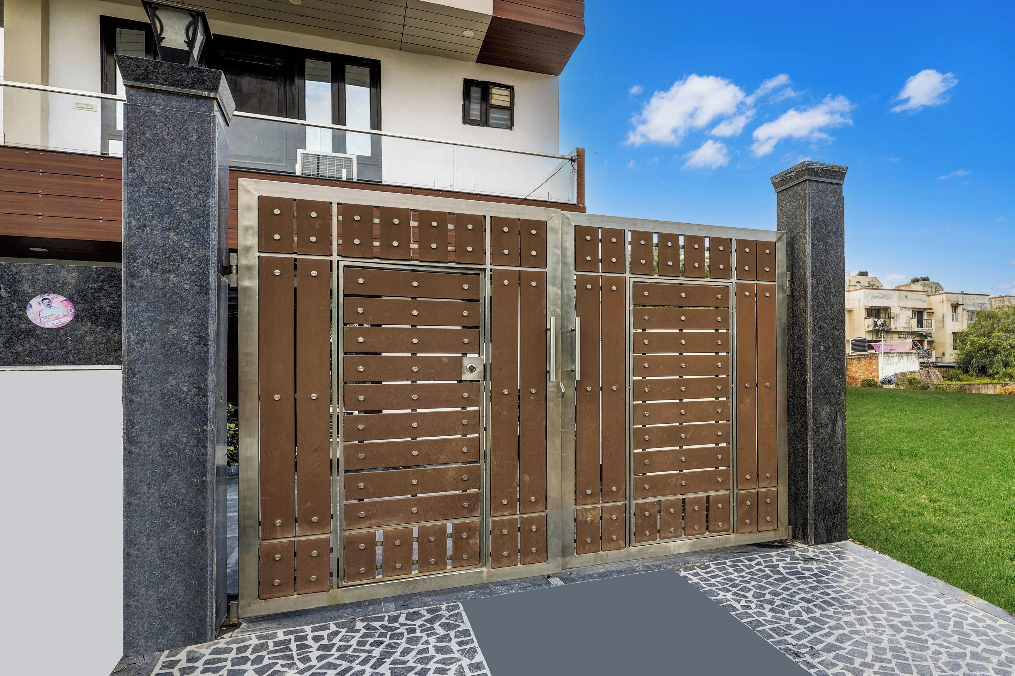 A gated entrance with a modern design, featuring a metal gate with horizontal bars and a central vertical panel.