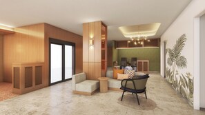 Un'ampia hall con zona salotto, reception e un murale con motivi tropicali.