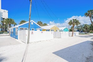 A gated area with a blue building, a yellow building, and a white building. - Blue Lagoon at White Sands| 2br/1ba close to beach (Indian Rocks Beach)