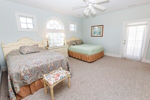 A bedroom with a large bed, a smaller bed, a chair, a dresser, and a door. - OCEANFRONT-Ocean Views, ELEV, Priv Pool, Hot Tub-S16, Voulez-Vous (Corolla)