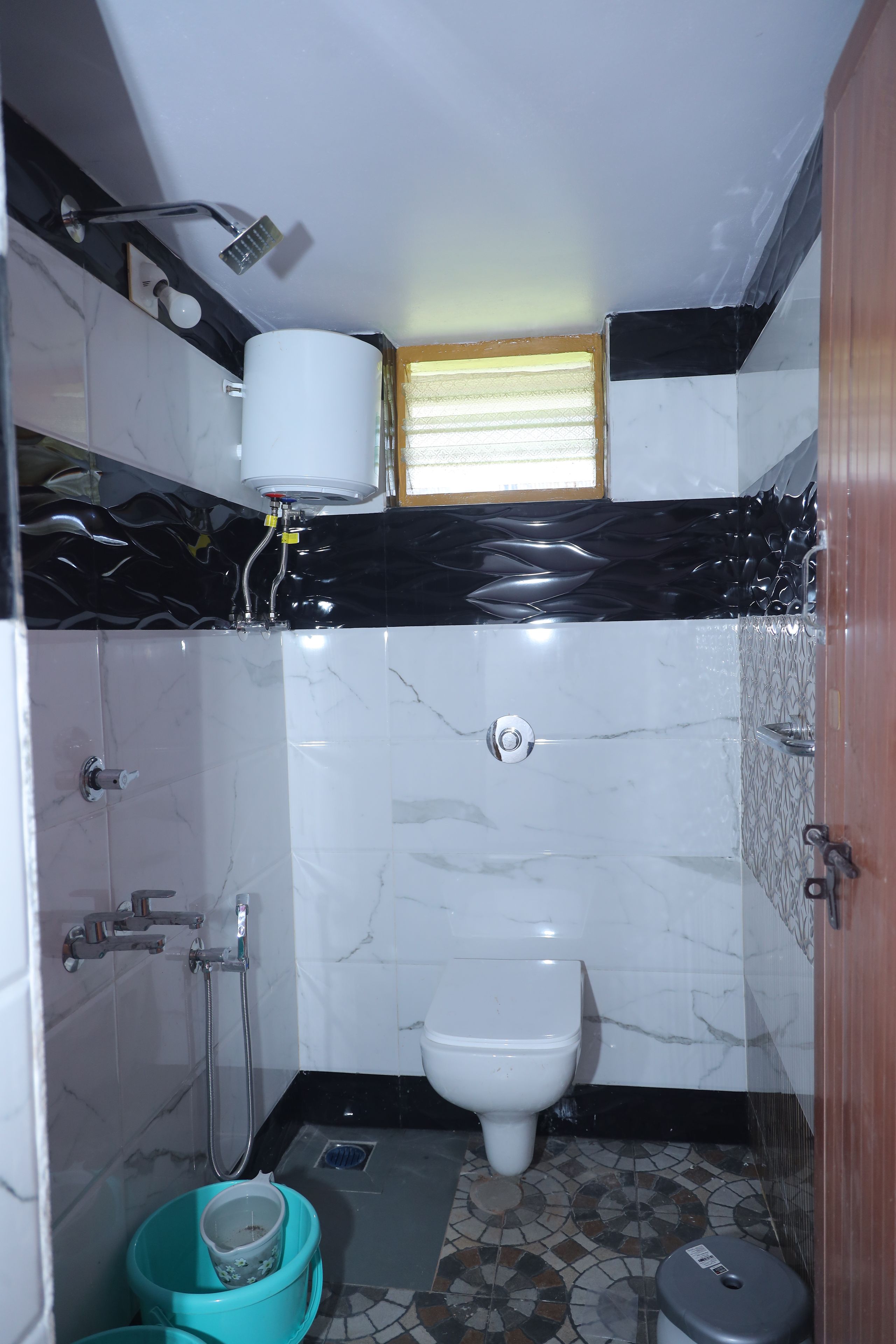 Un baño pequeño con inodoro, ducha y lavamanos.