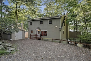 A two-story house with a front porch and a covered patio area. - Lakefront w/ Private Shoreline | Kayaks + Paddle Boards + Firepit | Covewood (Lakeville)
