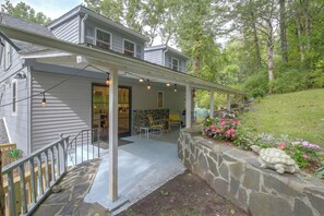 A house with a covered porch, stone retaining wall, and outdoor seating area. - Wooded Retreat w/ Porch & Fire Pit in Stone Ridge (Stone Ridge)