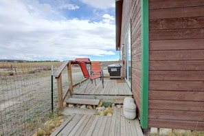 A wooden deck with outdoor seating and a white toilet. - Walkable Fairplay Home w/ Mtn Views! (Fairplay)