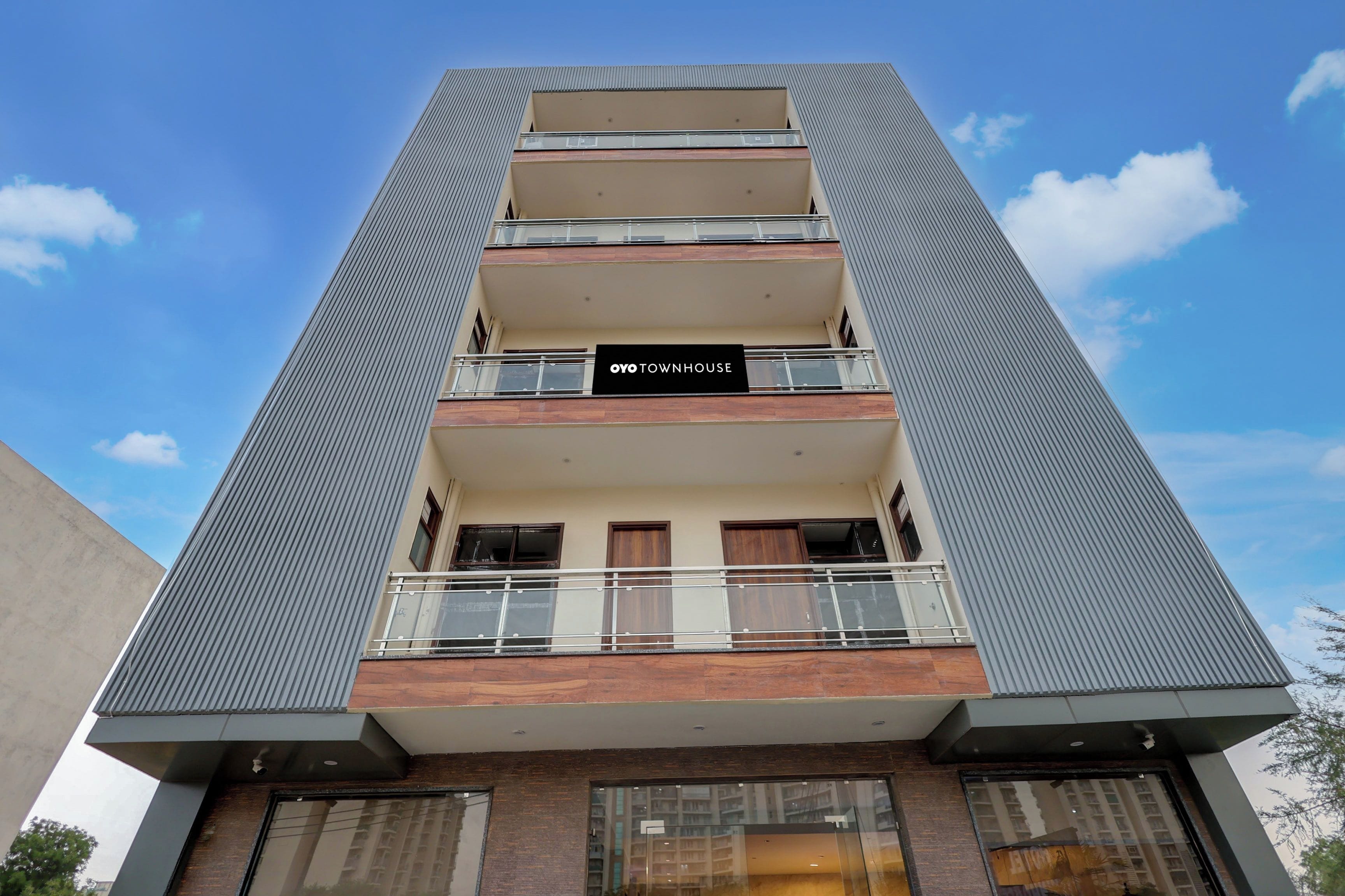 A multi-story building with a sign reading 'OYO TOWNHOUSE'.