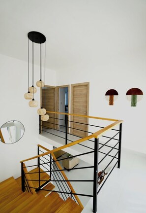 A modern staircase with wooden steps and metal railings, leading to an upper floor. - Paradise Private Pool Villa (Punta Cana)