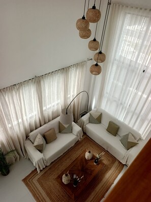 A modern living room with a sectional sofa, a coffee table, and woven pendant lights. - Paradise Private Pool Villa (Punta Cana)