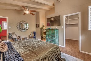 A bedroom with a bed, a ceiling fan, a dresser, a television, and a closet. - Walk to Midtown! Mountain-View Ruidoso Retreat (Ruidoso)