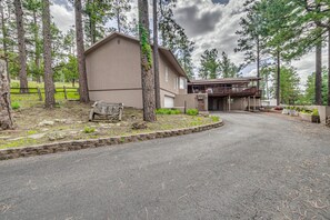 A two-story building with a covered porch and a garage. - Walk to Midtown! Mountain-View Ruidoso Retreat (Ruidoso)