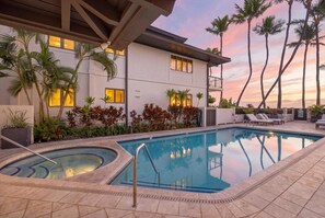 A modern hotel with a swimming pool, palm trees, and a sunset sky. - Luxury Oceanfront 3 Bedroom on Lahaina Baby Beach (Lahaina)