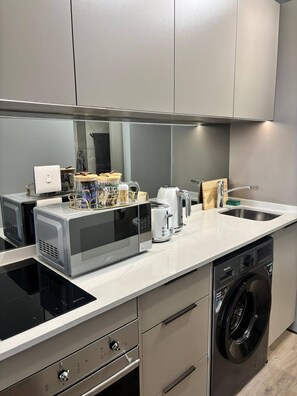 A modern kitchen with a built-in microwave, toaster, and dishwasher. - Rosebank Retreat, business or leisure (Johannesburg)