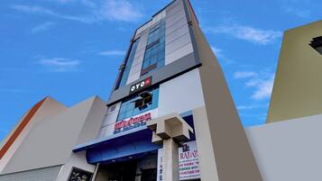 A multi-story building with a prominent 'OYO' sign on the facade.