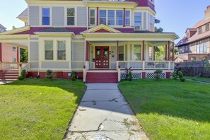 A two-story house with a front porch, a red door, and a small front yard. - Extended Springfield Stay Near Downtown & MGM (Springfield)