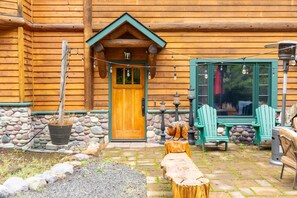 Cedar siding, a stone base and string lights welcome you home. - NEW | 3 Mi to Whitefish Mountain | Ski + Snowshoe | Cedar Home, Stone Fireplace, Sleeps 8 (Whitefish)