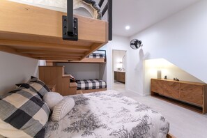 A bedroom with a bunk bed, a desk, a chair, a dresser, and a fan. - New! Family Ski Getaway with Hot Tub, Chef's Kitchen & Fireside Deck, Monthly Stays (Whitefish)