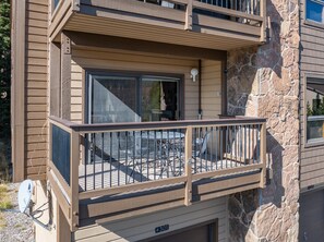 Un immeuble à plusieurs étages doté d’un balcon aménagé avec du mobilier d’extérieur et d’une antenne parabolique.