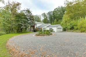 A two-story house with a gravel driveway and a well-maintained lawn. - 3 Mi to Wadsworth Falls! Retreat w/ Backyard Oasis (Middletown)