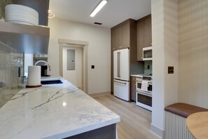 A modern kitchen with marble countertops, a built-in oven, and a refrigerator. - Walk to Old Town Eats, Shops! Modern Home w/ Yard (Sherwood)