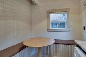 A room with a built-in bench, a window with blinds, and a radiator. - Walk to Old Town Eats, Shops! Modern Home w/ Yard (Sherwood)