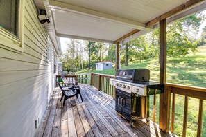 A covered porch with a grill and chairs. - Cozy Vintage Charm Located Between US 60 & I-64 (Ashland)