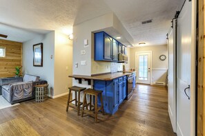 A modern kitchen with blue cabinets, a wooden countertop, and a built-in oven. - Steps to Lake! Home w/ Deck & Views in Conesus (Conesus)