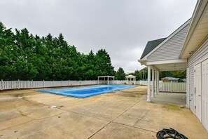 A residential backyard with a swimming pool, a covered patio area, and a white fence. - Rehoboth Beach Group Getaway! 5 Mi to Boardwalk (Rehoboth Beach)