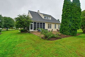 A two-story house with a large front porch, a covered patio, and a well-maintained lawn. - Rehoboth Beach Group Getaway! 5 Mi to Boardwalk (Rehoboth Beach)