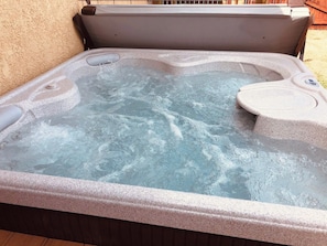 A hot tub with a control panel, surrounded by a concrete edge. - Poncha Springs Home Near Salida & Buena Vista (Poncha Springs)