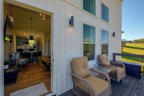 A modern home interior with a kitchen, dining area, and a deck with outdoor seating. - Hike, Explore & Unwind: Scenic Blue Ridge Escape (Floyd)