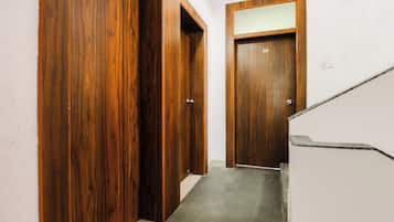 A hallway with wooden doors numbered 202 and 204, leading to a staircase.