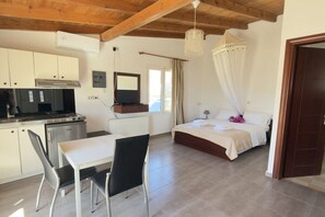 A bedroom with a bed, a bedside table, a window, and a view of the outdoors. - Villa in Pitsidia with swimming pool (Pitsidia)