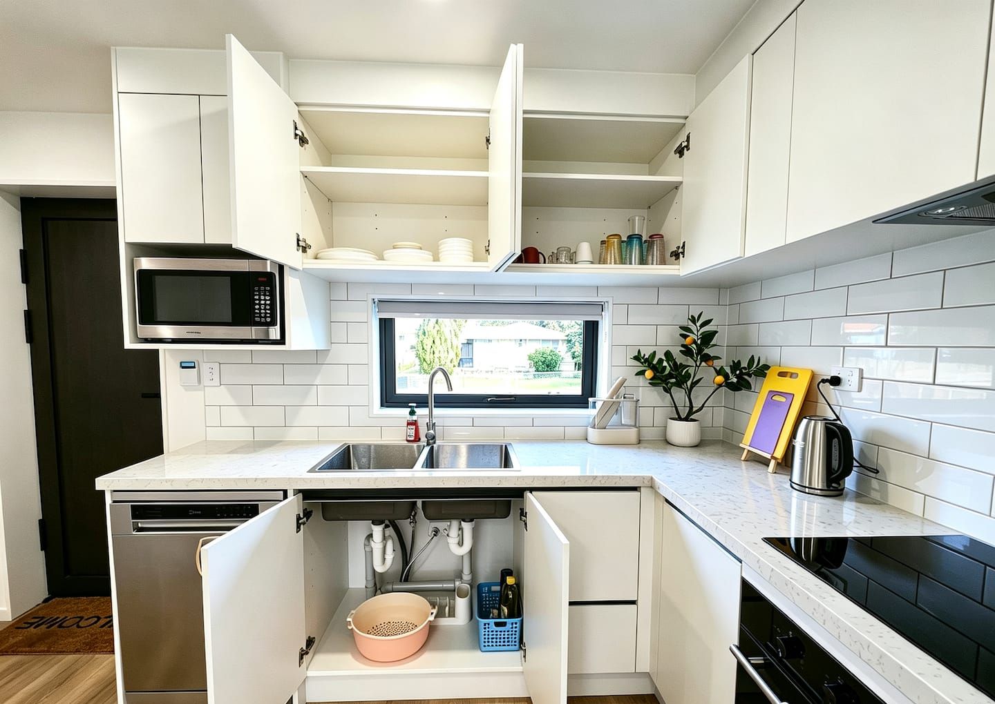 Even washing up feels brighter with sunshine and a view — a practical kitchen designed for everyday living.