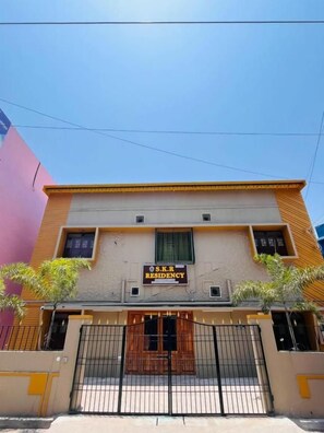 A multi-story building with a sign reading 'S.K.R RESIDENCY.'