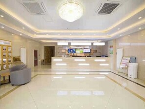 A hotel lobby with a reception desk, a chandelier, and a seating area. - Greentree Inn Beijing Tongzhou District Xuxinzhuang Subway Station Express Hotel (Tongzhou)