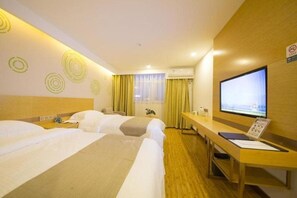 A hotel room with three beds, a desk with a TV, and a window with curtains. - Greentree Inn Beijing Tongzhou District Xuxinzhuang Subway Station Express Hotel (Tongzhou)