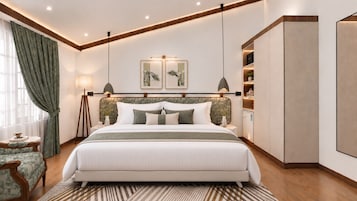 A modern bedroom with a large bed, bedside tables, a wardrobe, and a view of the outdoors.