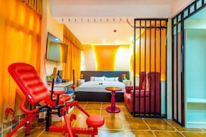 A hotel room with a bed, exercise equipment, a TV, and a red chair. - Haihao Business Hotel (Chongqing)