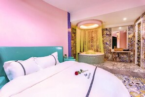 A hotel room with a bed, a bathroom with a sink and mirror, and a decorative wall. - Haihao Business Hotel (Chongqing)