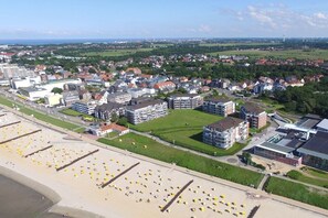 A coastal town with a beach, residential buildings, and a large open field. - Strandpalais, Apt. 209 (Cuxhaven)