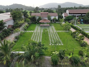 A residential area with a well-maintained lawn, a gazebo, and a playground. - Spree One Resort and Convention (Shankhavaram)