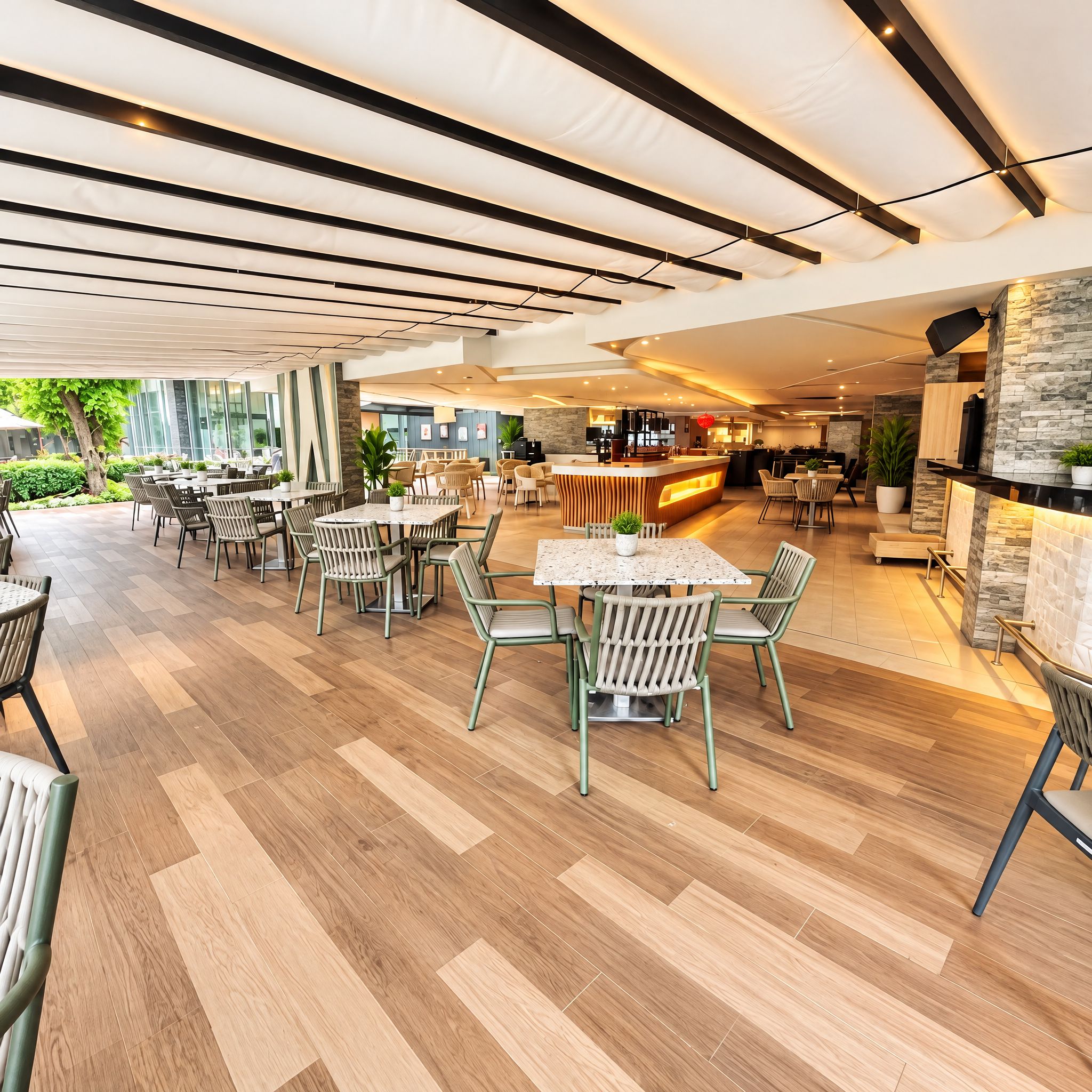 Un espacio interior amplio con diversas disposiciones de asientos, un mostrador de recepción y una zona de bar.